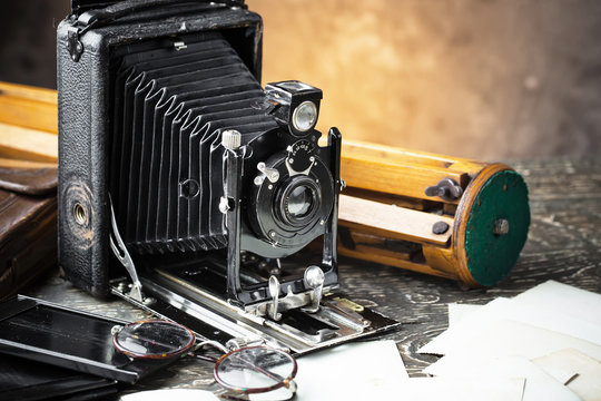 Old camera on an old background on a close-up table