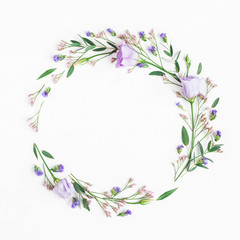 Flowers composition. Wreath made of pink flowers and eucalyptus branches on white background. Flat lay, top view