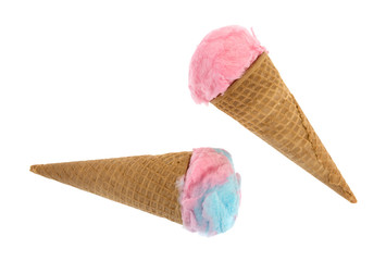 Two cotton candy shaped as ice cream in a sugar cones isolated on a white background.