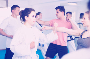 Fototapeta na wymiar Men and women learn karate