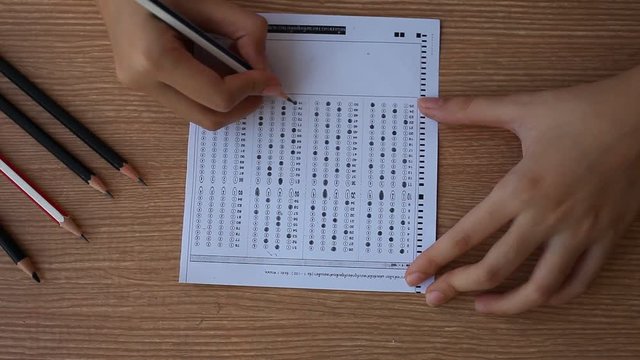 Right hand take examination and erasing thai language