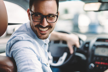 Portrait of a handsome businessman driving car