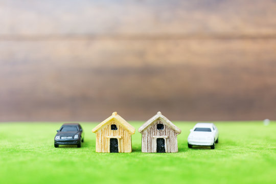 Miniature bamboo house and car on green yard