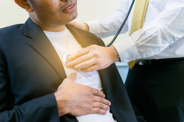 Doctor checking patient heartbeat using stethoscope