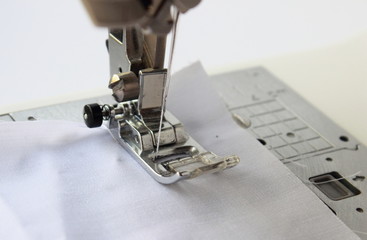 sewing machine with fabric isolated on white background