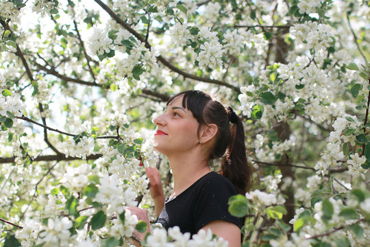 girl in a spring apple flower garden