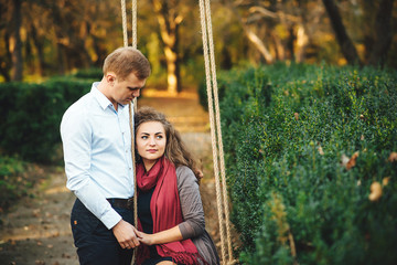 Beautiful young loving couple walking outdoors at the park.