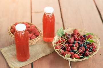 Two bottles of cold stewed fruit from assorted berries.