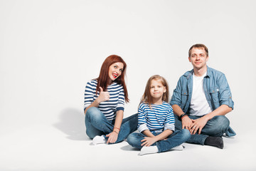 Happy family portrait sitting on white background isolated