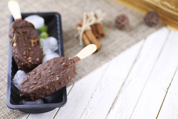 Dessert chocolate ice cream with nuts on wooden stick