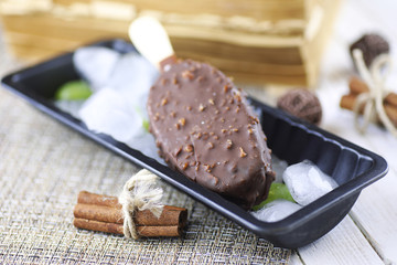 Dessert chocolate ice cream with nuts on wooden stick