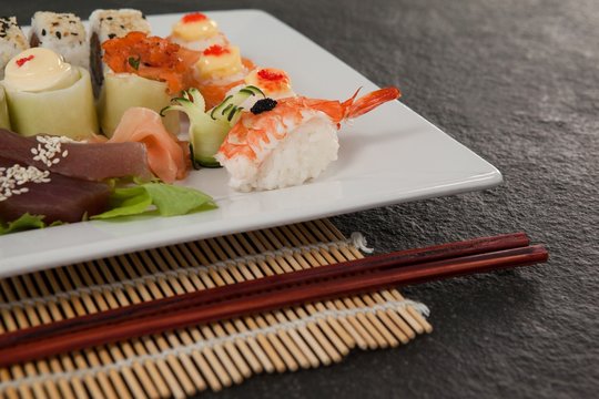 Assorted sushi set served with chopsticks 