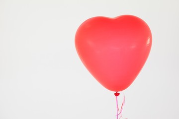 Fototapeta na wymiar Heart-shaped red balloon