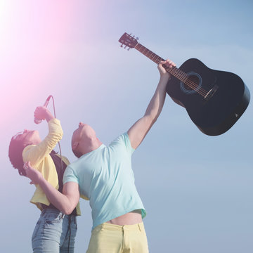 Pretty girl, singer, singing to mic with handsome man, guitarist,