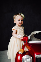 two babies wedding - girl dressed as bride playing with toy car