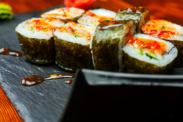 Spicy sushi rolls with sweet honey sauce