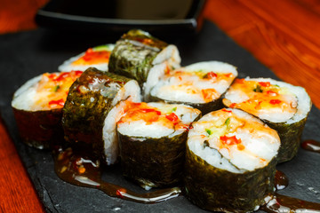 Spicy sushi rolls with sweet honey sauce