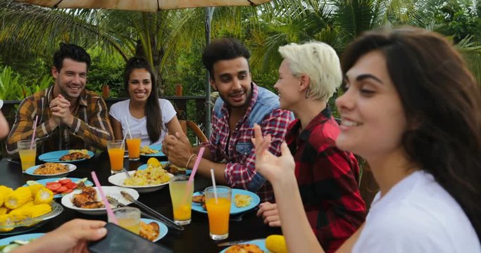 People Talking Sitting At Table Outdoors Eating On Terrace Young Friends Group Happy Smiling Closeup Communication Slow Motion 60