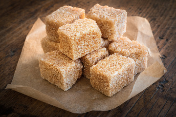 Cube cane sugar on wood desk