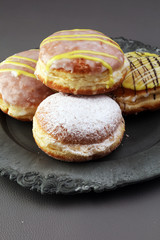 German donuts - berliner with jam and icing sugar in a tray on a