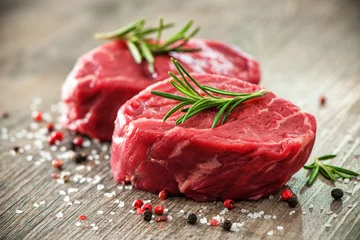 Tuinposter Raw beef fillet steaks with spices © Alexander Raths