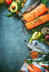 Assortment of fresh fish with aromatic herbs, spices and vegetables