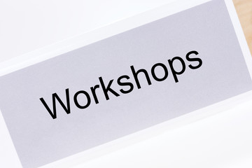 Office folder with the label workshops on white background