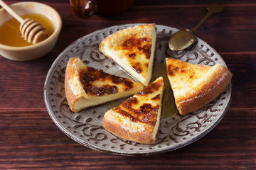 Baked pudding with honey on brown plate
