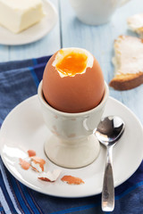Egg in an egg-cup with toasts and butter