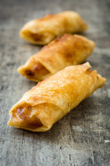 Vegetable spring rolls on wooden table background
