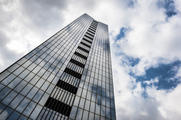 Fototapeta na wymiar glass high rise building clouds sky reflection
