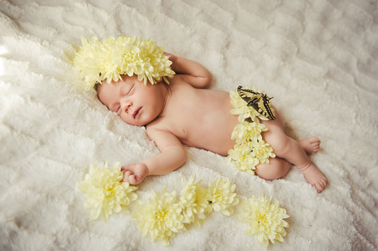 Portrait close up studio Shot of Eight day old Smiling newborn baby is sleeping on white wool blanket with yellow flowers.