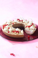 Contemporary Ring Tart with Red Currants and Coconut Cream (inside) on purple plate, on light pink background.