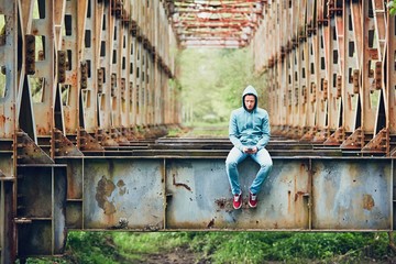 Sad man on the abandoned bridge