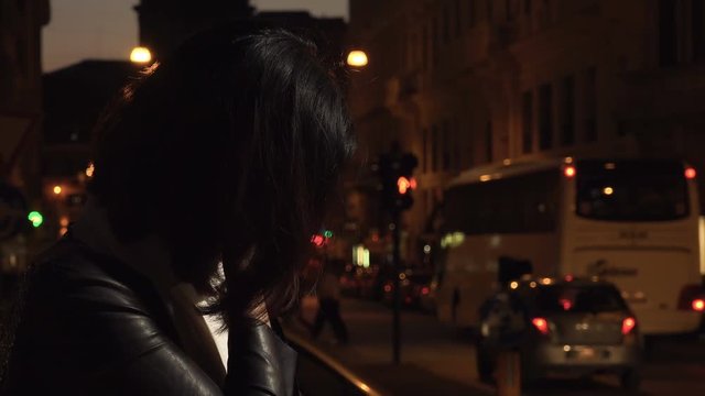 Sad depressed Chinese woman's profile alone in the street at night