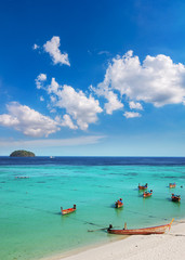 Tropical white sand and Long tail boat and blue sea of Andaman Sea with blue sky background. Lipe Island, Satun, Thailand.