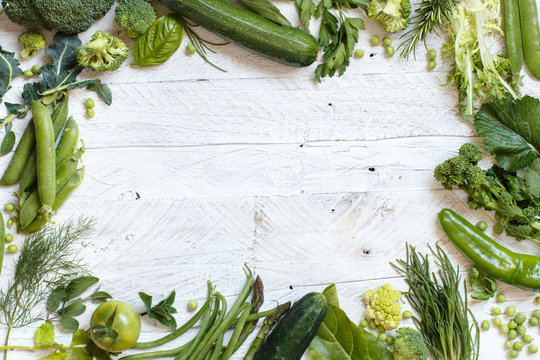 Fototapeta Green vegetables on a wooden table