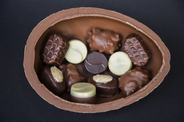 Delicious chocolate truffles pralines on a black background image.