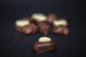Delicious chocolate truffles pralines on a black background image.