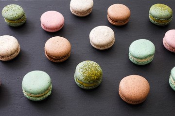 Macarons cake, top view flat lay, pattern macaroon on black background