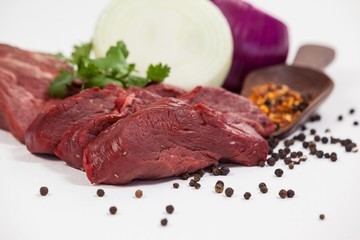 Beef steak and spices against white background