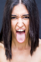 Portrait of a beautiful woman  with her tongue out of her mouth
