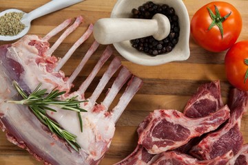 Rib rack, rib chops and ingredients on wooden board