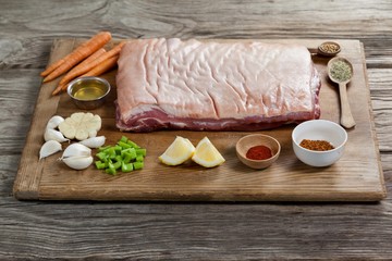 Beef brisket and ingredients on wooden board