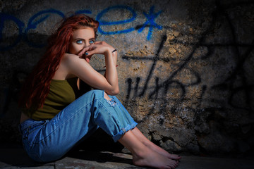 Beautiful redhead with blue eyes posing outdoor