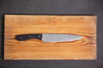 Knife on wooden board