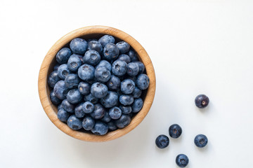 Bowl of blueberries isolated on white. Top view