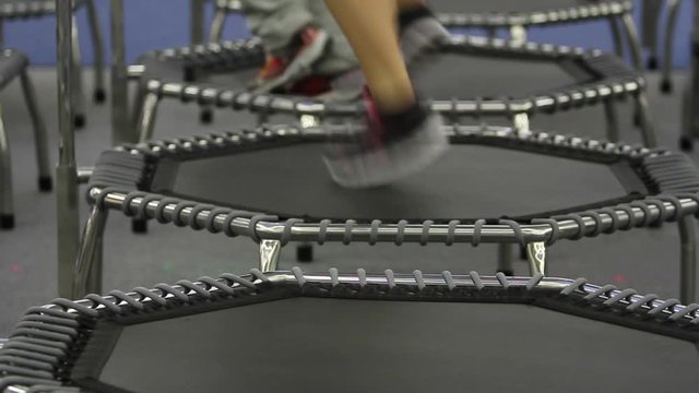 Young girl doing Fitness Exercise on a Mini Trampoline, full HD video 