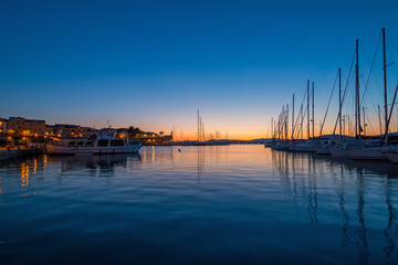 Alghero cityscape seen from the harbor at night, Italy