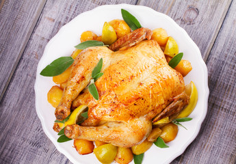 Chicken with Lemon, Lime and Potato Garnished with Sage. View from above, top studio shot